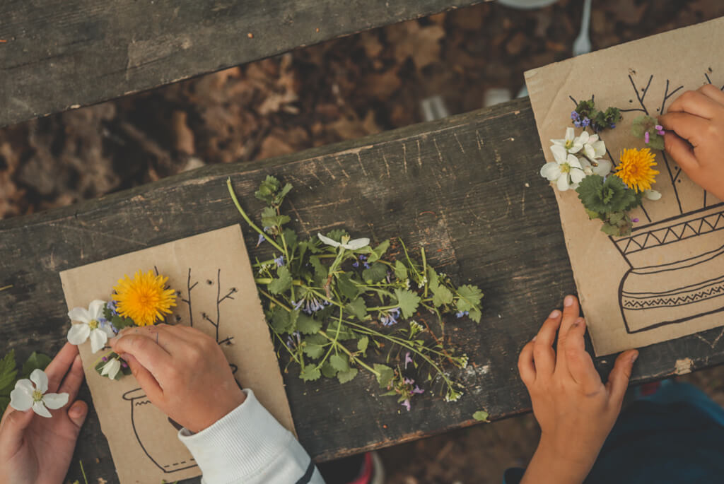 Children making pictures with flowers
