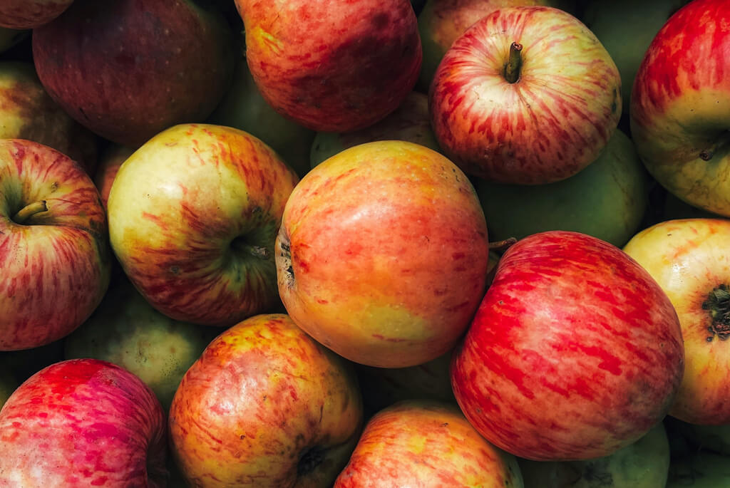 Bright red and green apples in a pile