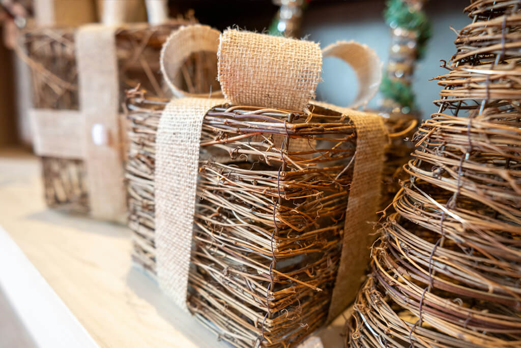 Small, woven willow Christmas present and Christmas tree ornaments