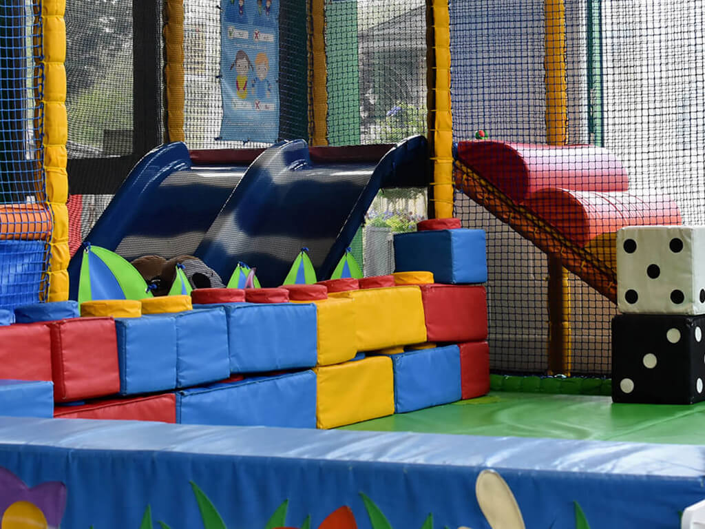 Soft play area and play frame in blue, green, yellow and red.
