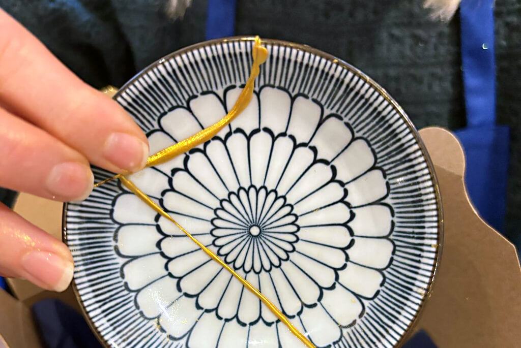 Japanese blue and white patterned dish with Kintsugi gold repairs