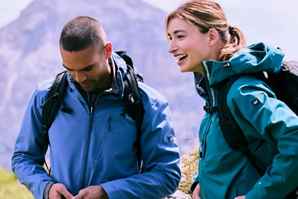 Man and a woman in walking gear on a hill